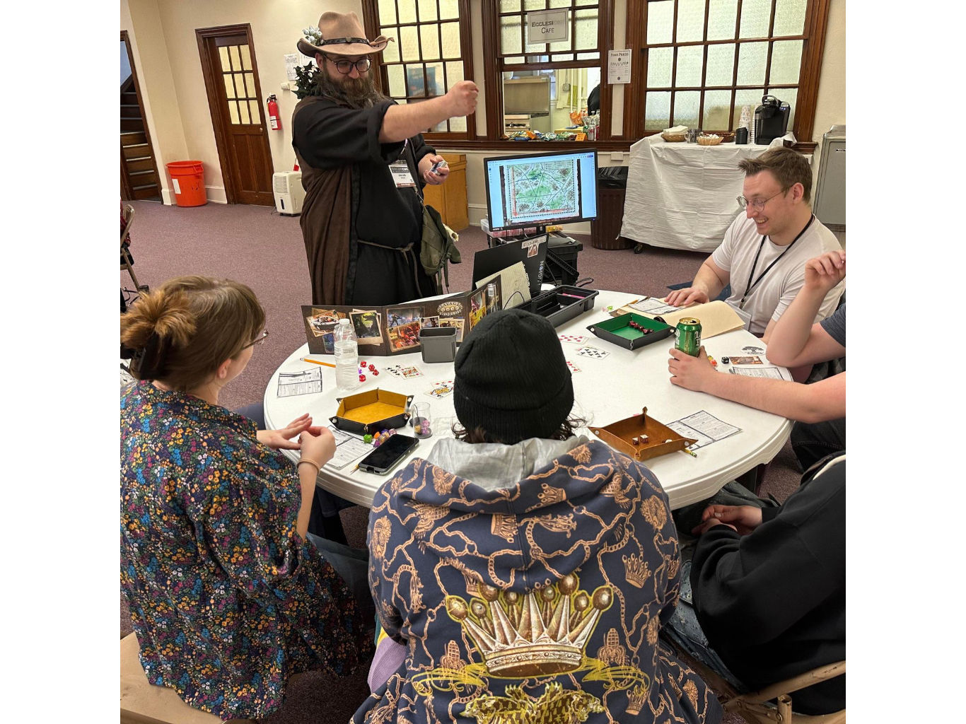 Gamemaster running a game for a happy table.