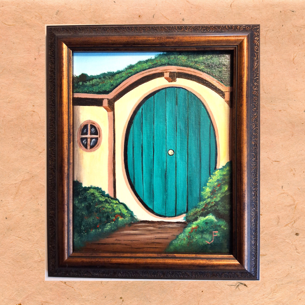 A path leading to a round hobbit door.