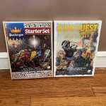 The Pendragon and Runequest starter packs leaning up against a wall.