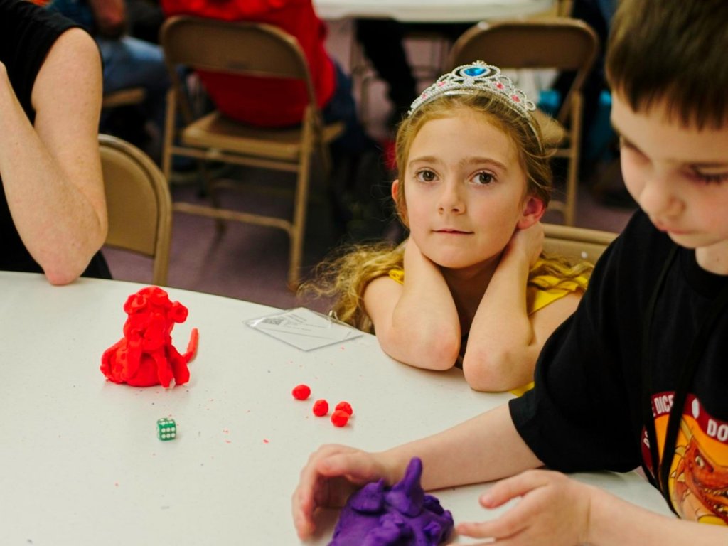 A young player waits a turn.