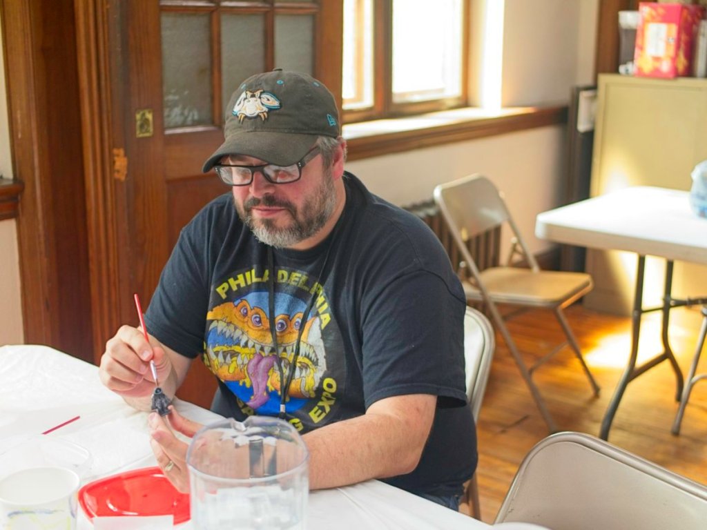 A player enjoyig a quite time painting minis.