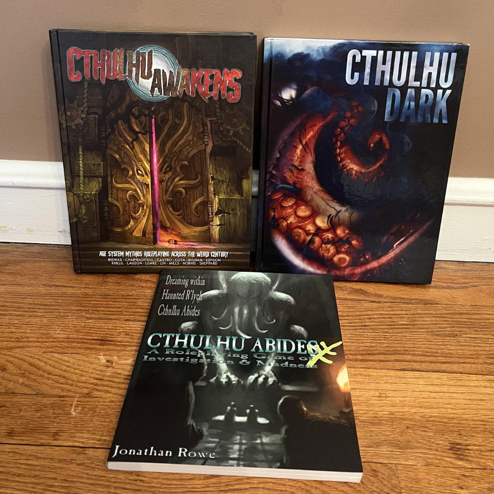 Cthulhu Awakens, Cthulhu Dark, and Cthulhu Abides rulebooks