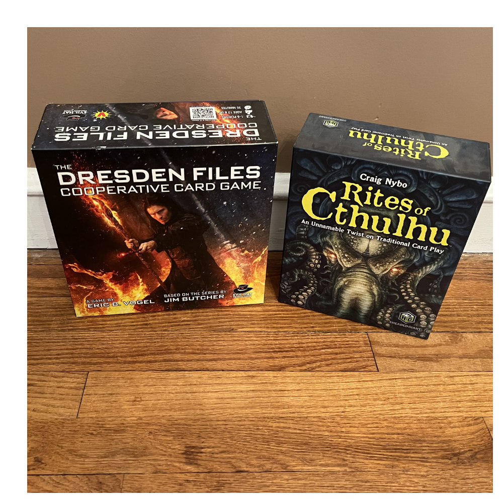 Dresden Files Cooperative Card Game and Rites of Cthulhu card game boxes.