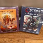 The Numenera and Cypher System starter sets next to each other.